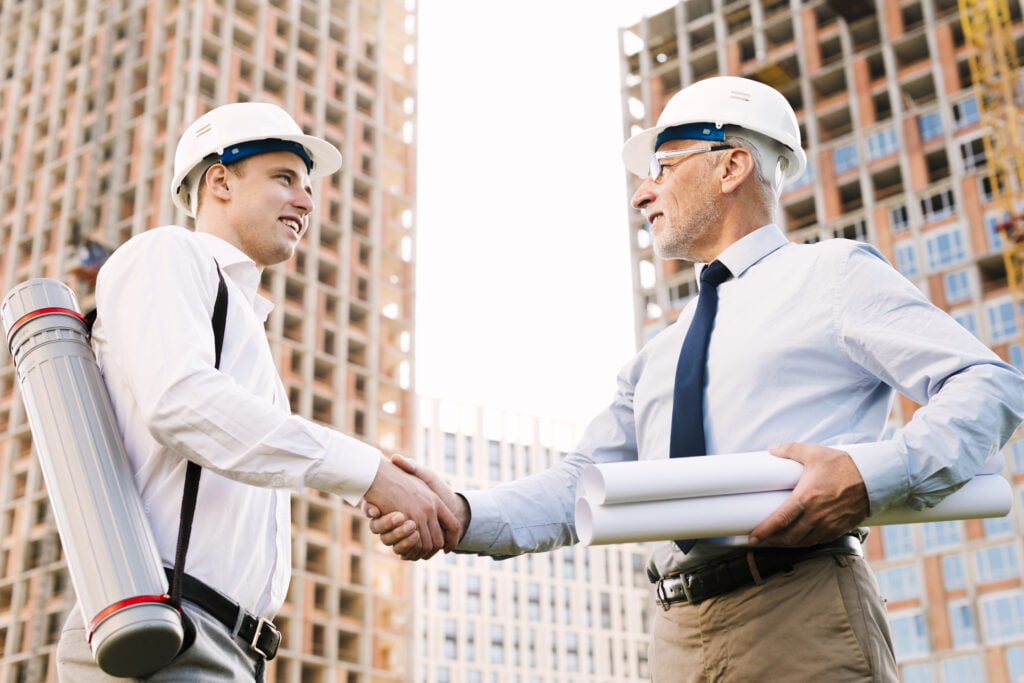 low angle architects shaking hands